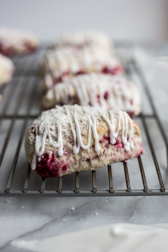 Raspberry Coconut Scones with Coconut Glaze on a cooling rack