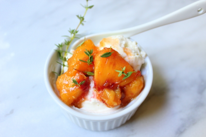a bowl of ice cream topped with nectarines and thyme