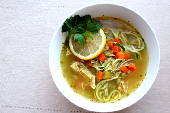 A bowl of Chicken Zoodle Soup with lemon and parsley