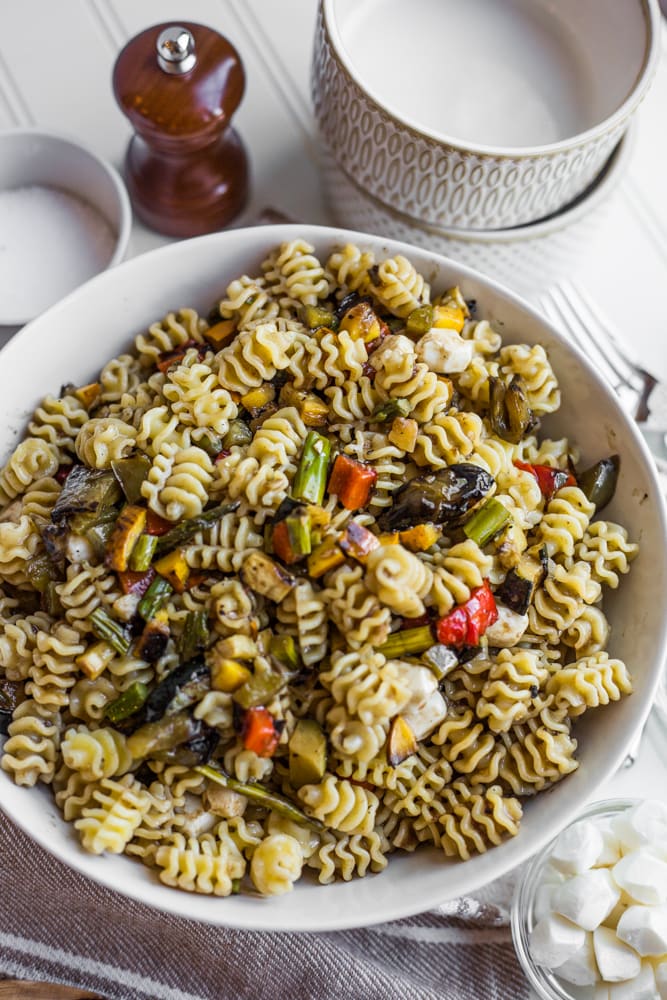 a bowl of pasta salad with grilled vegetables