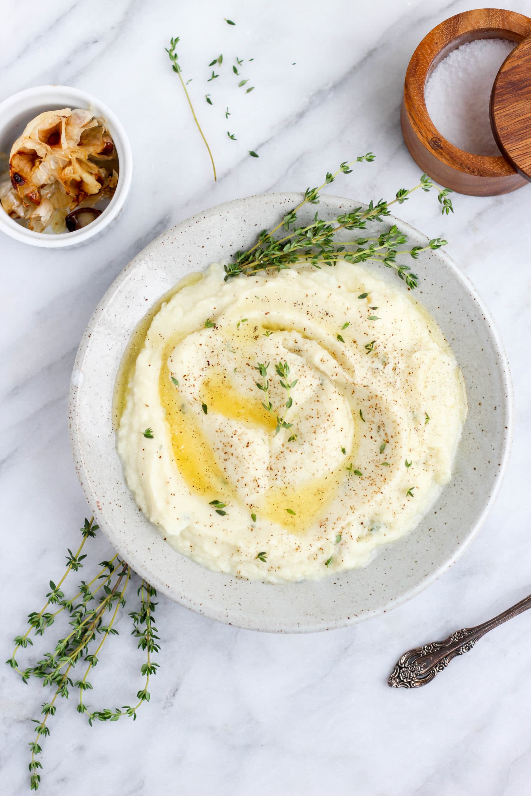Bowl of mashed cauliflower with roasted garlic and thyme