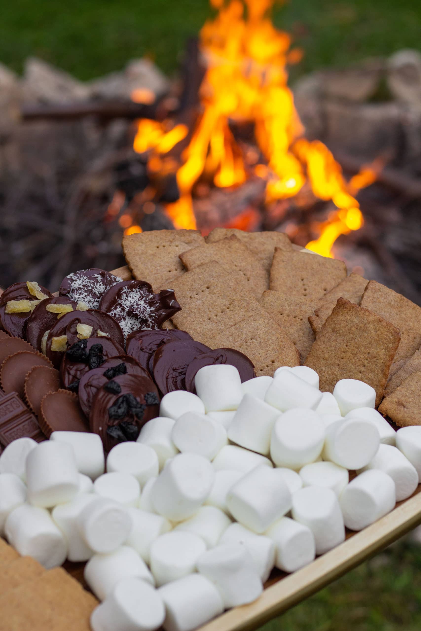 a platter filled with homemade graham crackers, marshmallows, and chocolate