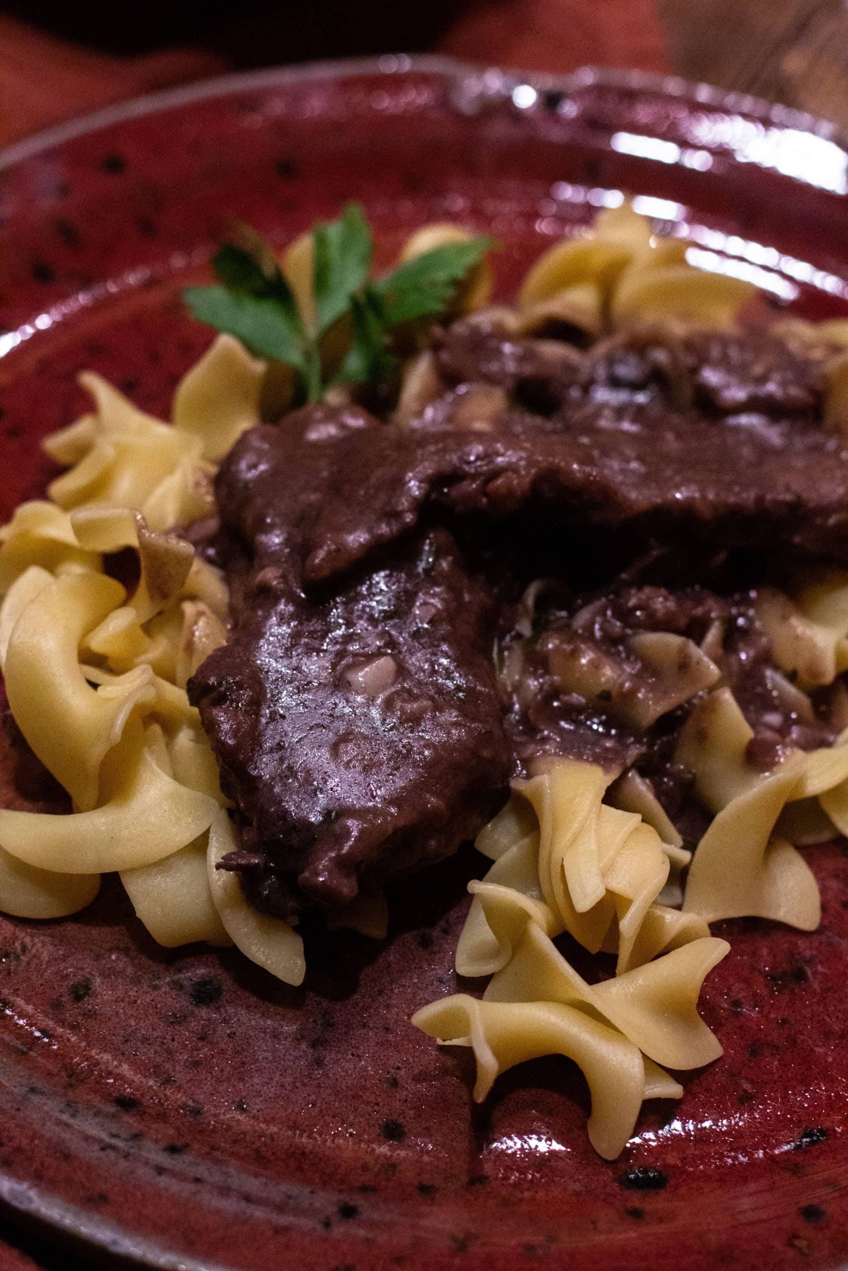 My Dad's Venison Burgundy showcases tender venison cooked in a rich red wine sauce. Served over wild rice, mashed potatoes, or rice.