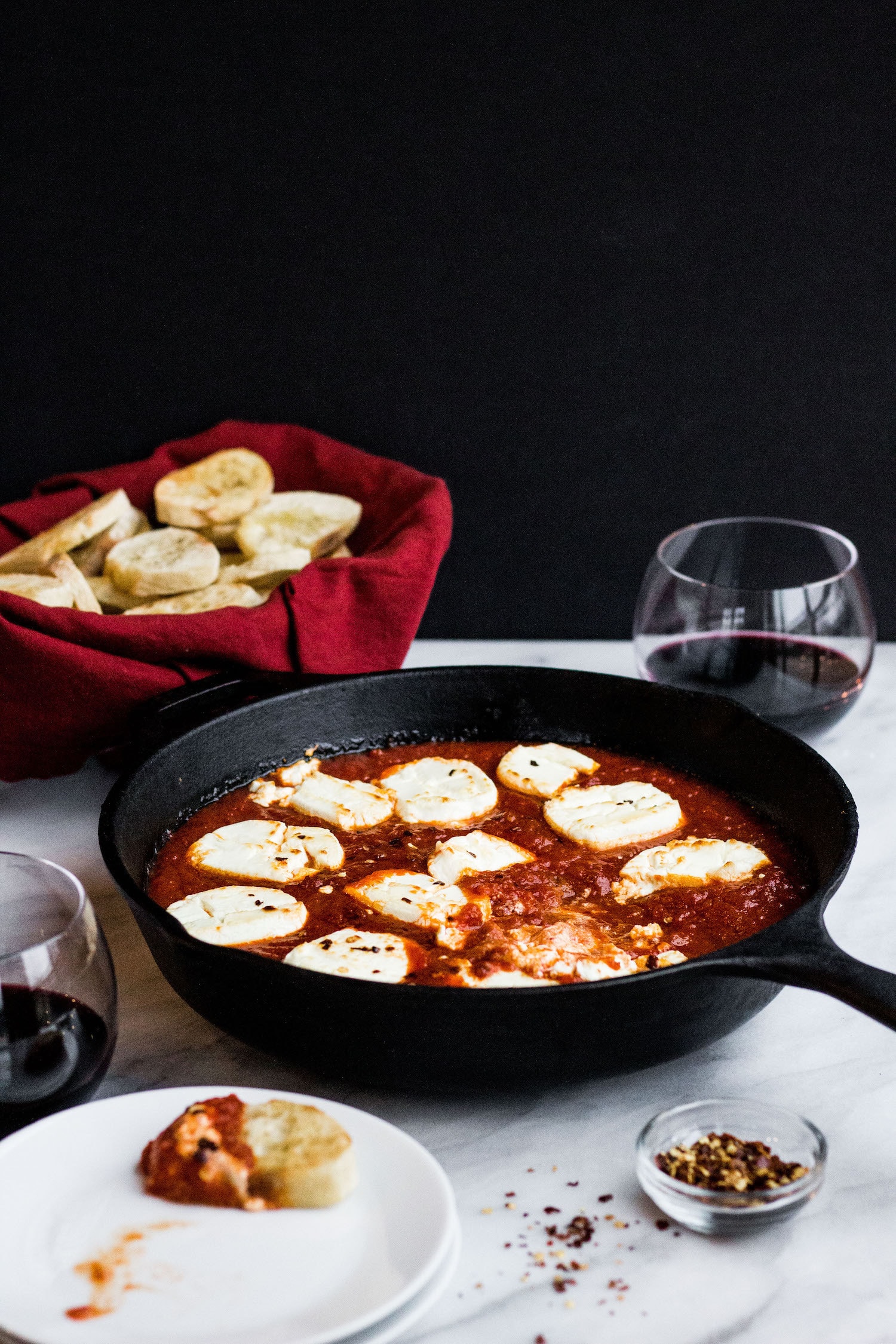 A cast iron pan filled with Goat Cheese Marinara Dip