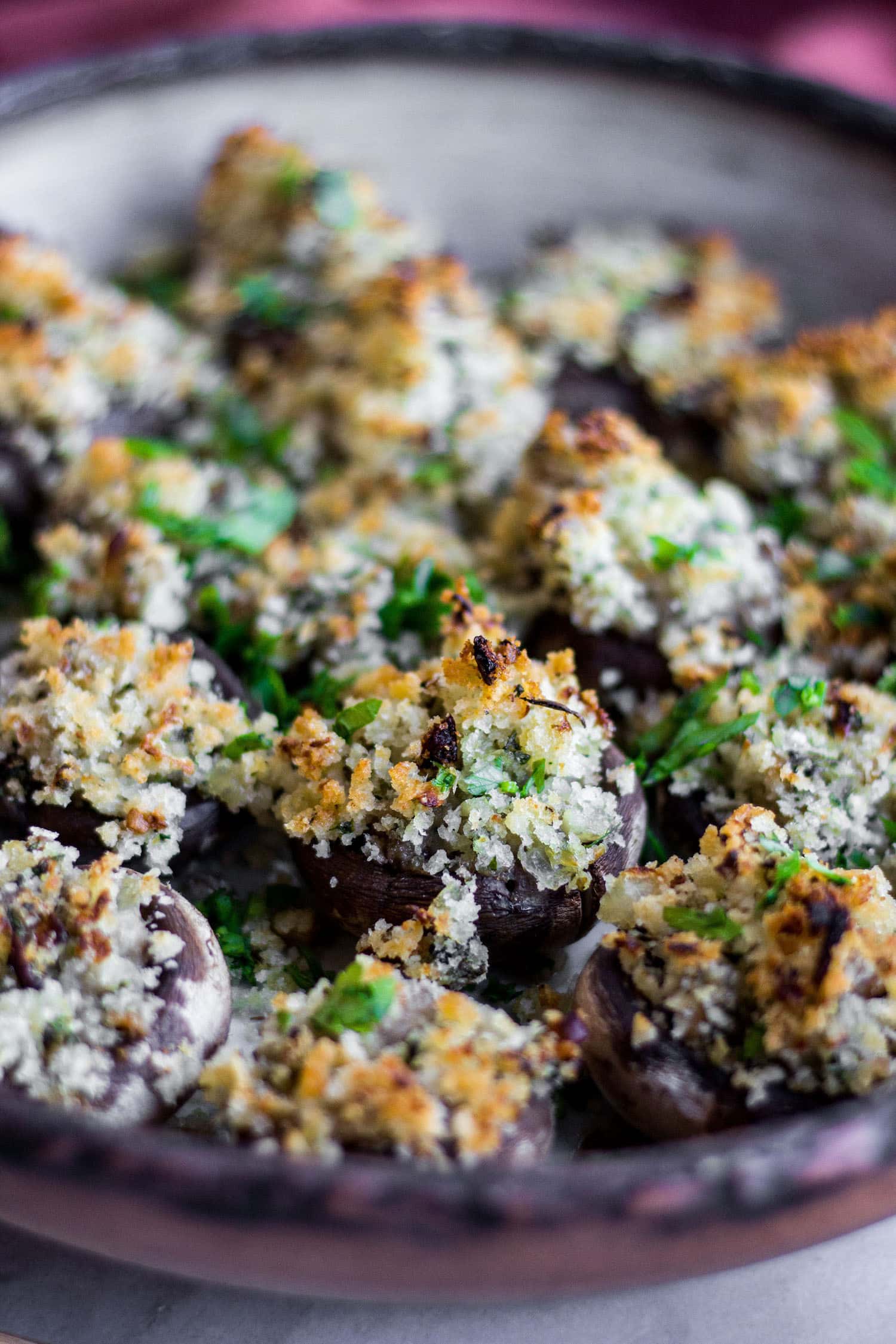 These Stuffed Mushrooms are simple and absolutely delicious! The mushrooms stems are chopped and sautéed with garlic, herbs, and breadcrumbs for a savory stuffing. 