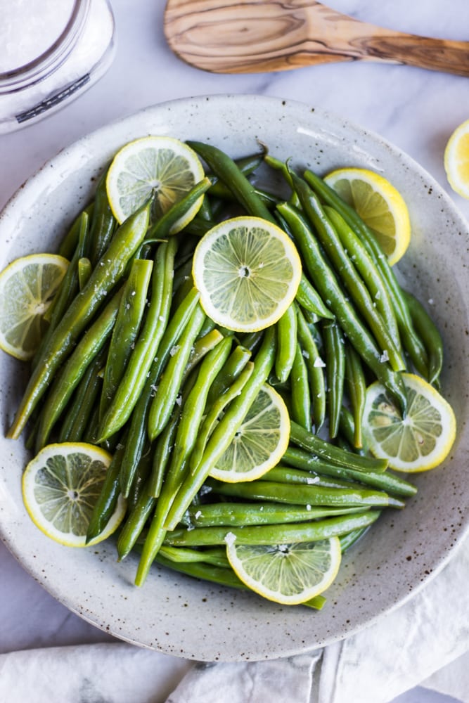 These Lemony Green Beans are bright, crisp, and addicting! Perfectly steamed green beans are tossed in a mouthwatering lemon sauce. Perfect as a side or on their own!