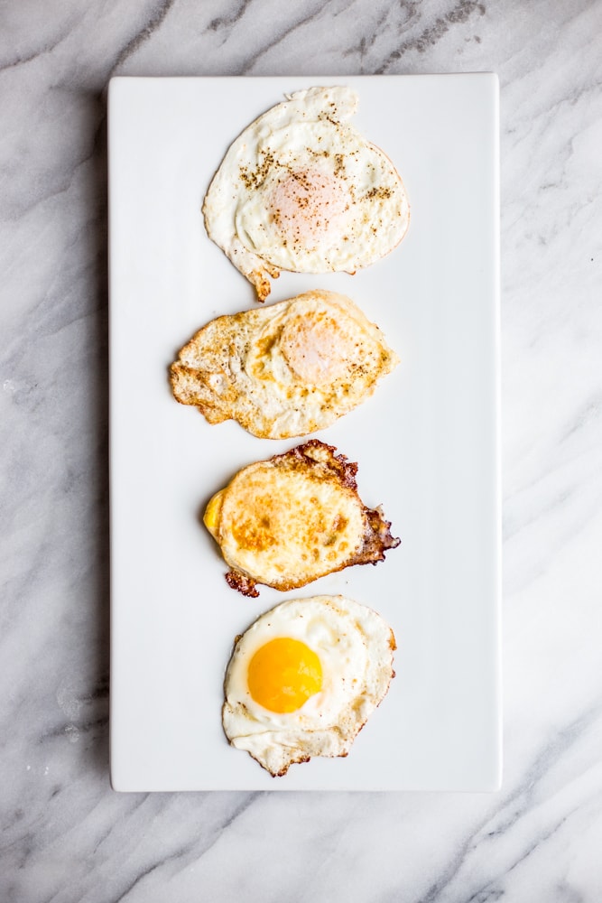 Over easy, over medium, over hard, and sunny side up eggs on a white platter