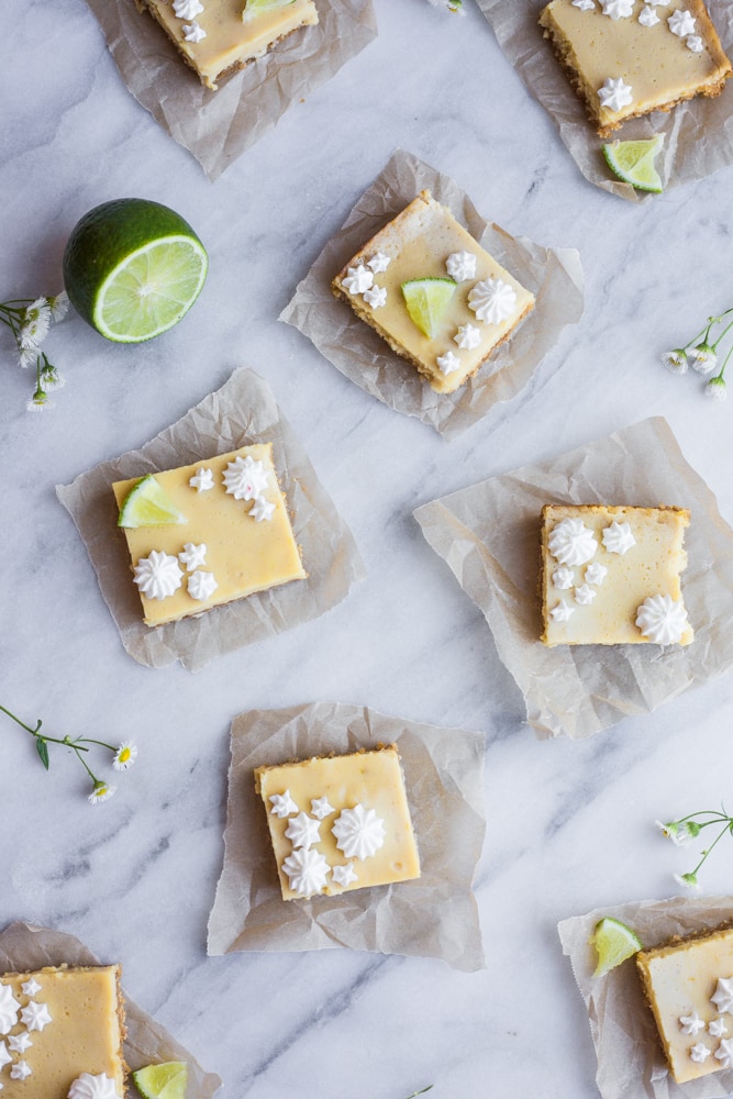 Key lime pie bars on a marble cutting board