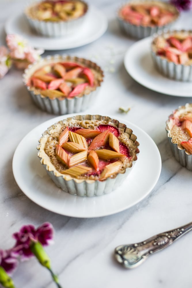 A marble platter with tarts topped with rhubarb