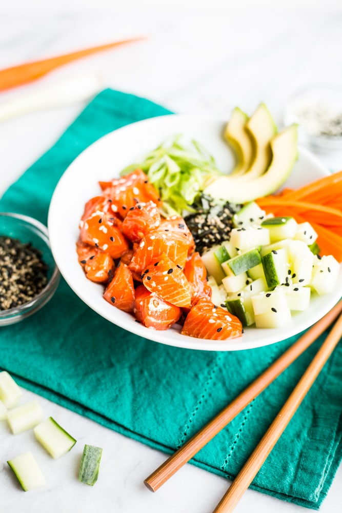 An ōra king salmon poke bowl with avocado, carrot, and cucumber