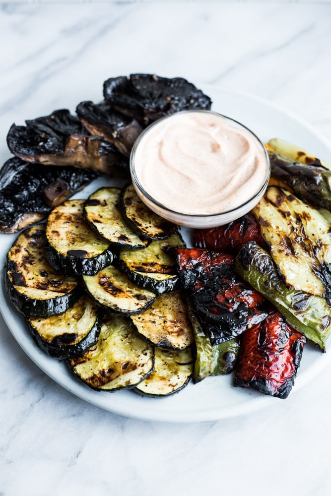 A platter of grilled vegetables with smoky aioli