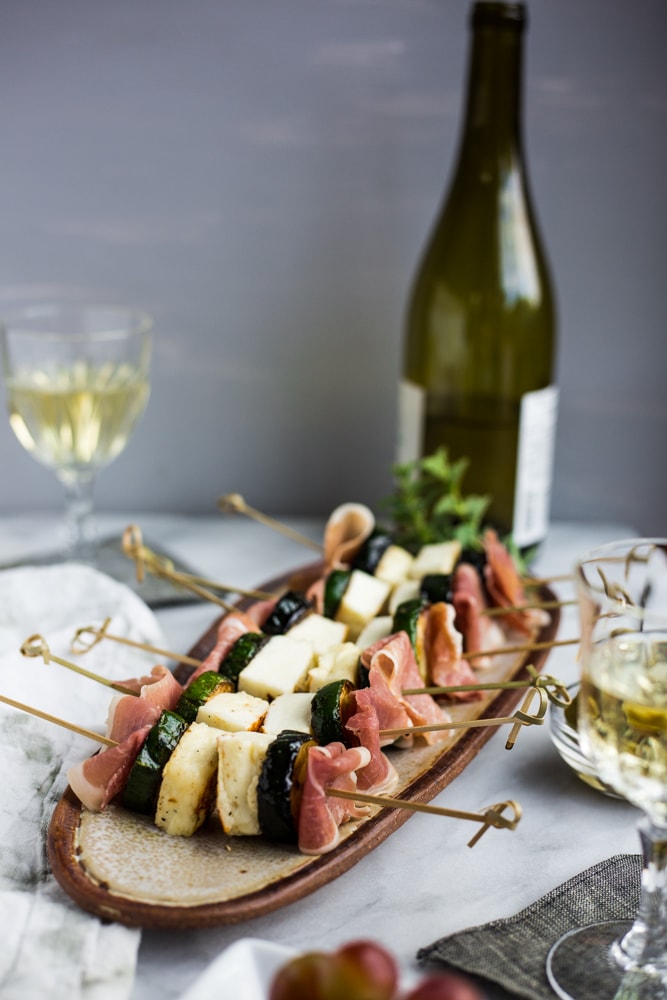 Grilled Zucchini, Halloumi, and Prosciutto Skewers on a platter