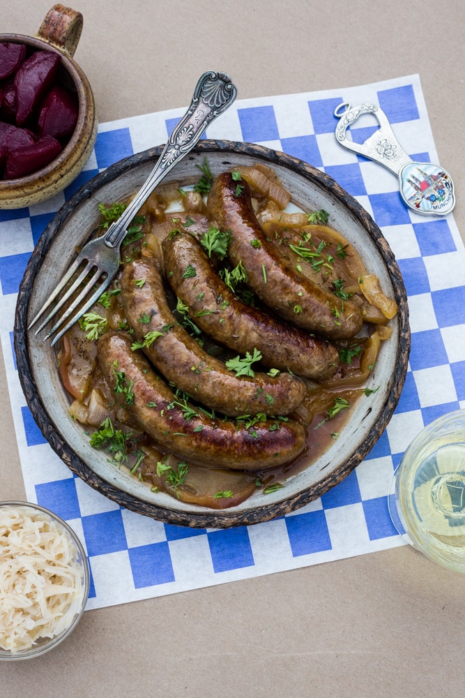 A plate of bratwurst with apples