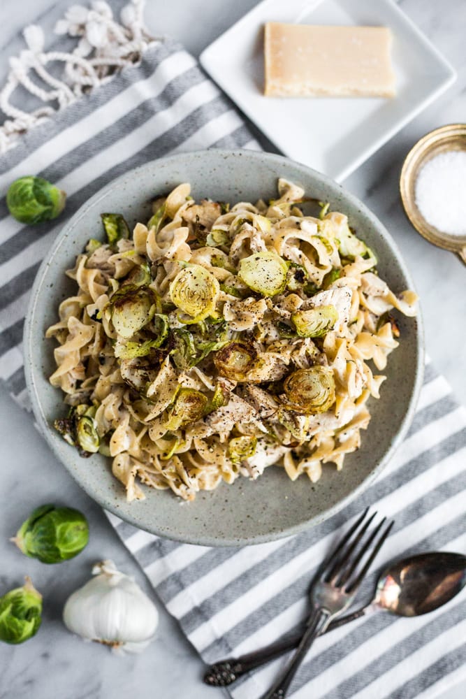 A plate of pasta with roasted chicken and Brussels sprouts