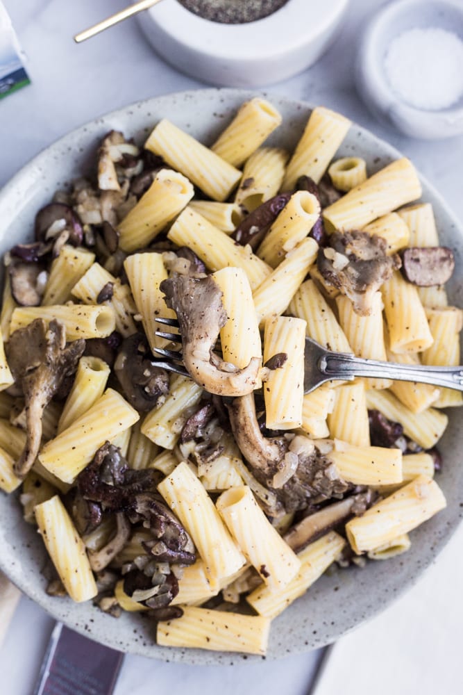 A plate of brown butter mushroom pasta with a fork