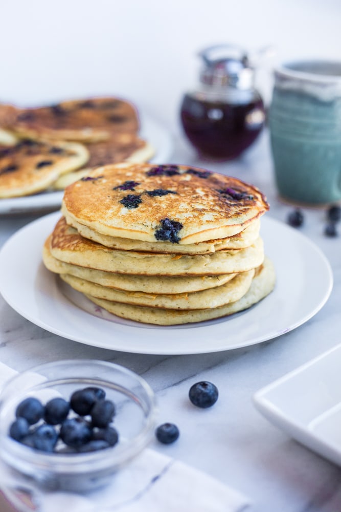 A stack of fluffy blueberry buttermilk pancakes