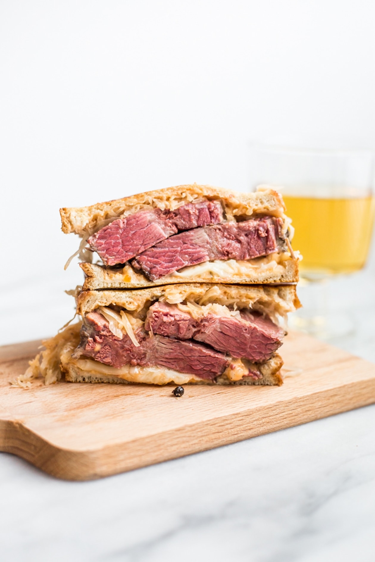 A classic reuben sandwich stacked on a cutting board
