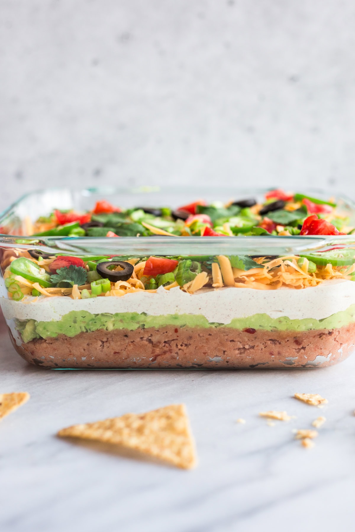 A glass dish filled with 7 layer taco dip