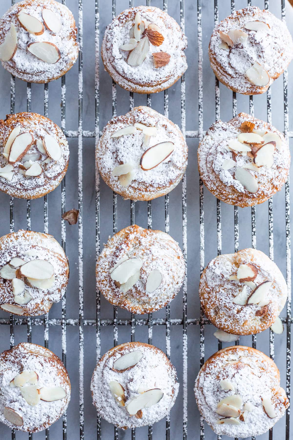 Almond croissant buns on a cooling rack